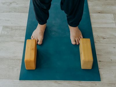 Yoga wooden blocks and a towel on floor